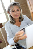 modern-mature-woman-shopping-online-home-senior-doing-33917221